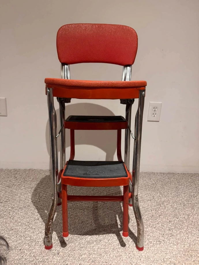 Mid-century step stool before restoration - original red vinyl seat and pitted chrome legs