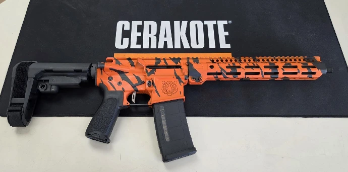 Right side of the TN-15 tiger stripe pistol with engraved tiger head, M-LOK handguard and SBA3 brace